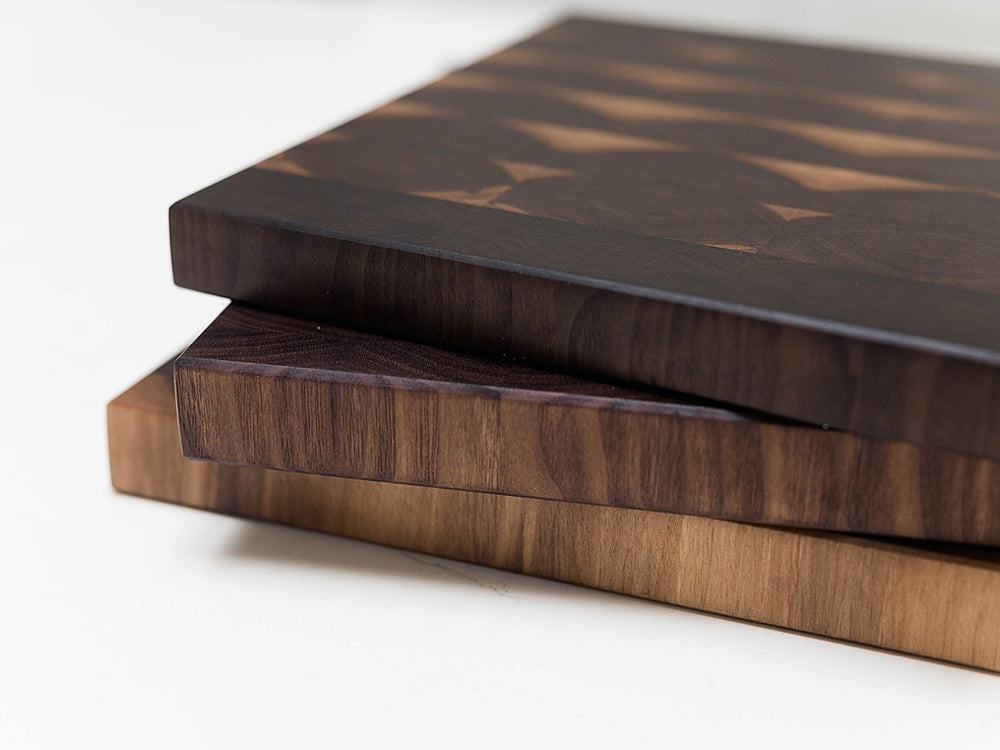 Three walnut end grain cutting boards on top of each other