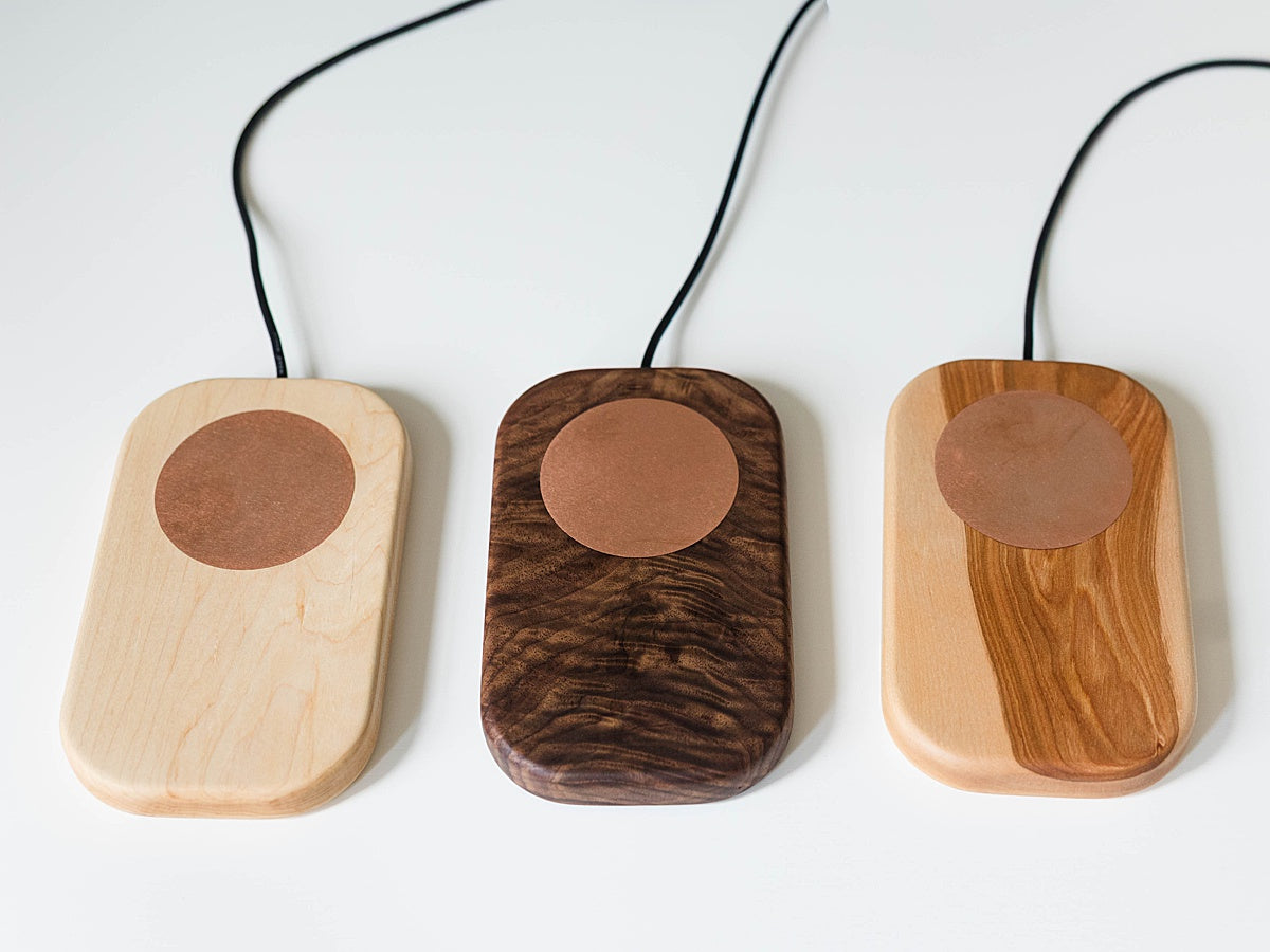 Three Laurel & Oak grounding boards in maple, birch, and walnut, made from solid wood with copper plates